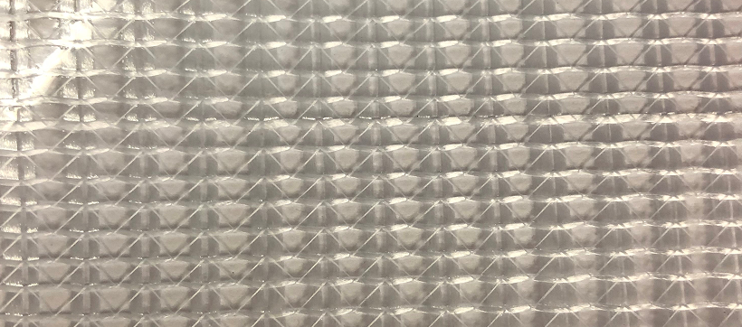 Close-up of clear ripstop laminated vinyl showing the grid reinforcement and glossy finish.